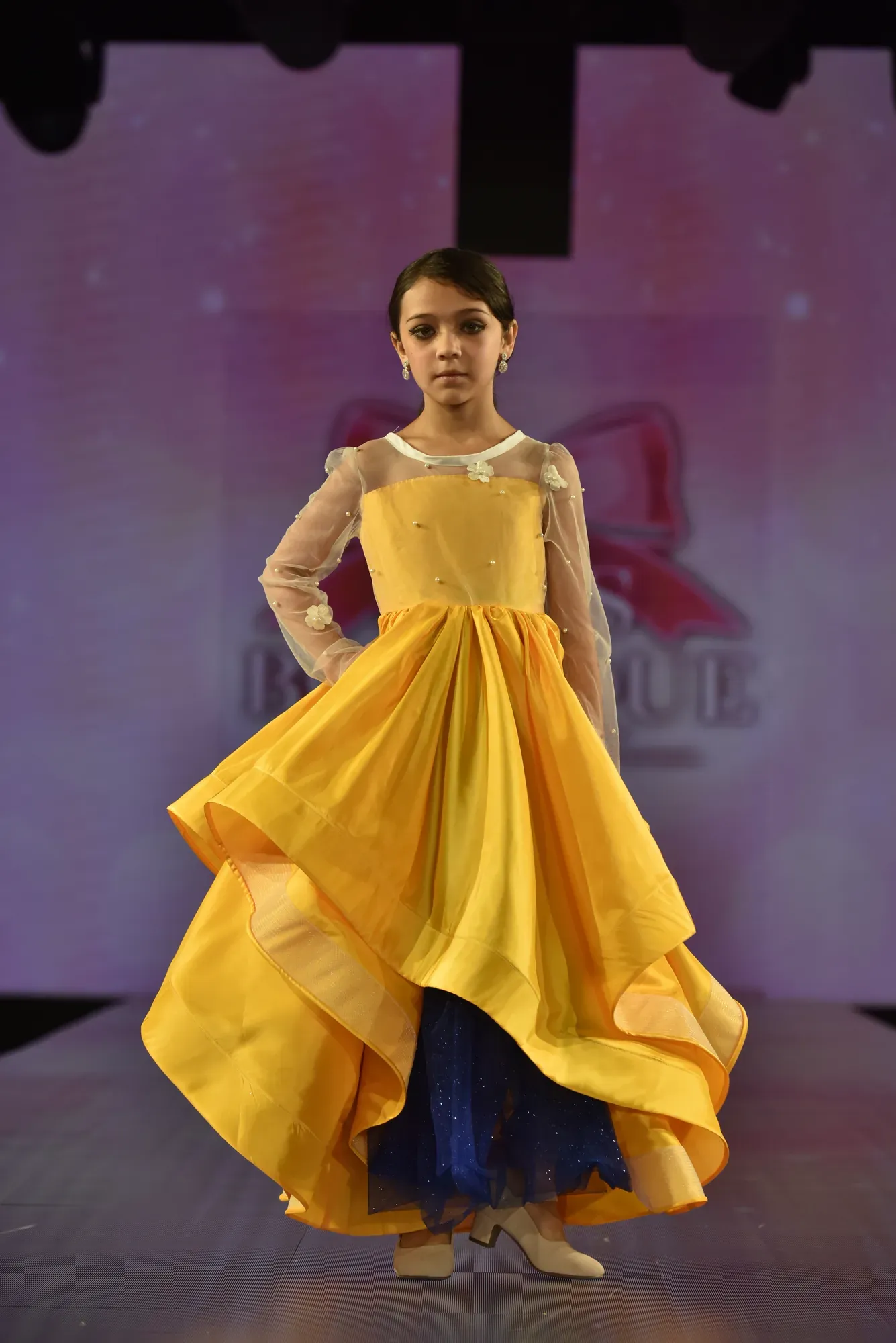 Marigold organza gown with pearl-set sleeves — Babs Boutique, Orlando Monroy Memorial Artist Collaboration Collection, New York Fashion Week