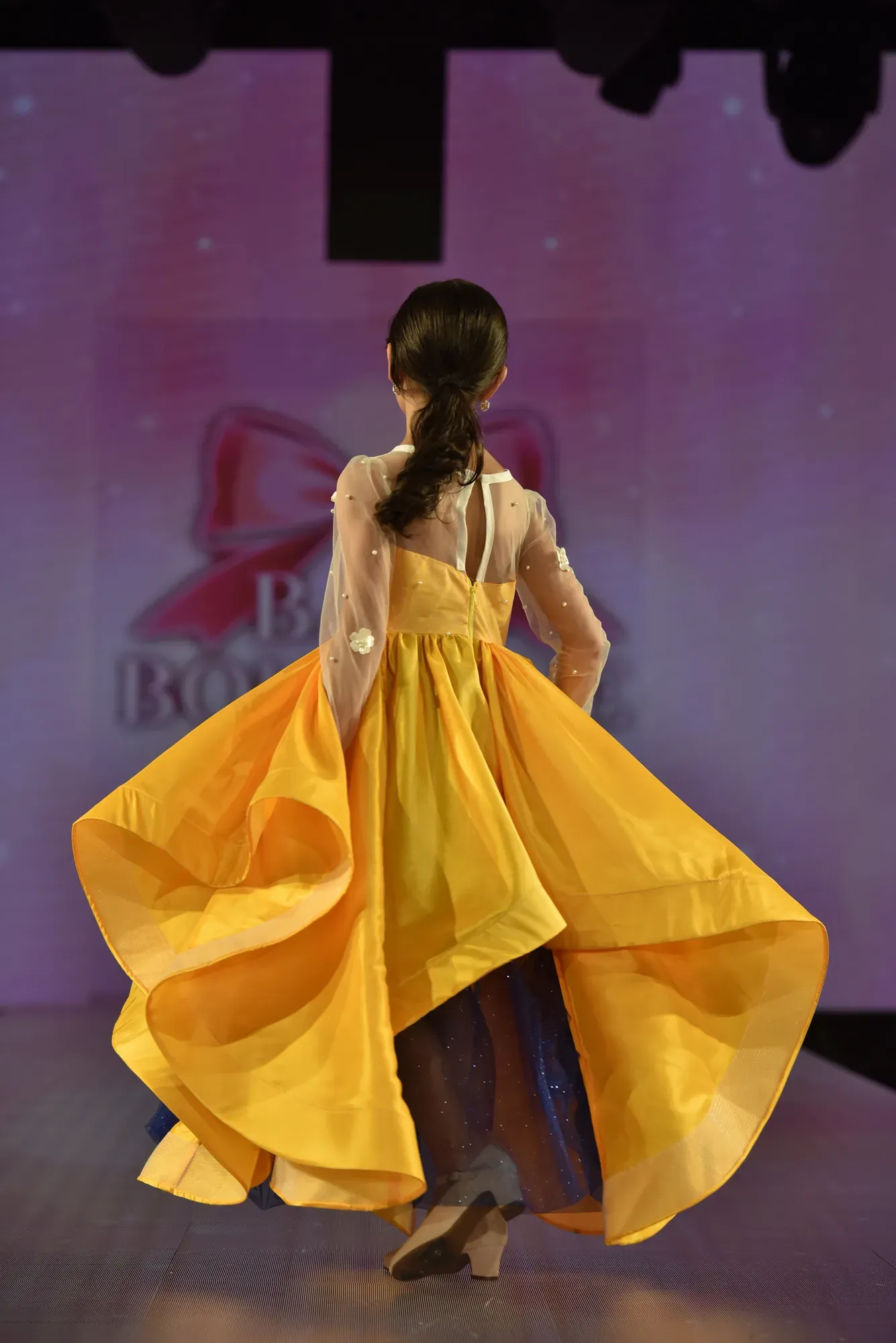 Marigold organza gown with pearl-set sleeves — Babs Boutique, Orlando Monroy Memorial Artist Collaboration Collection, New York Fashion Week