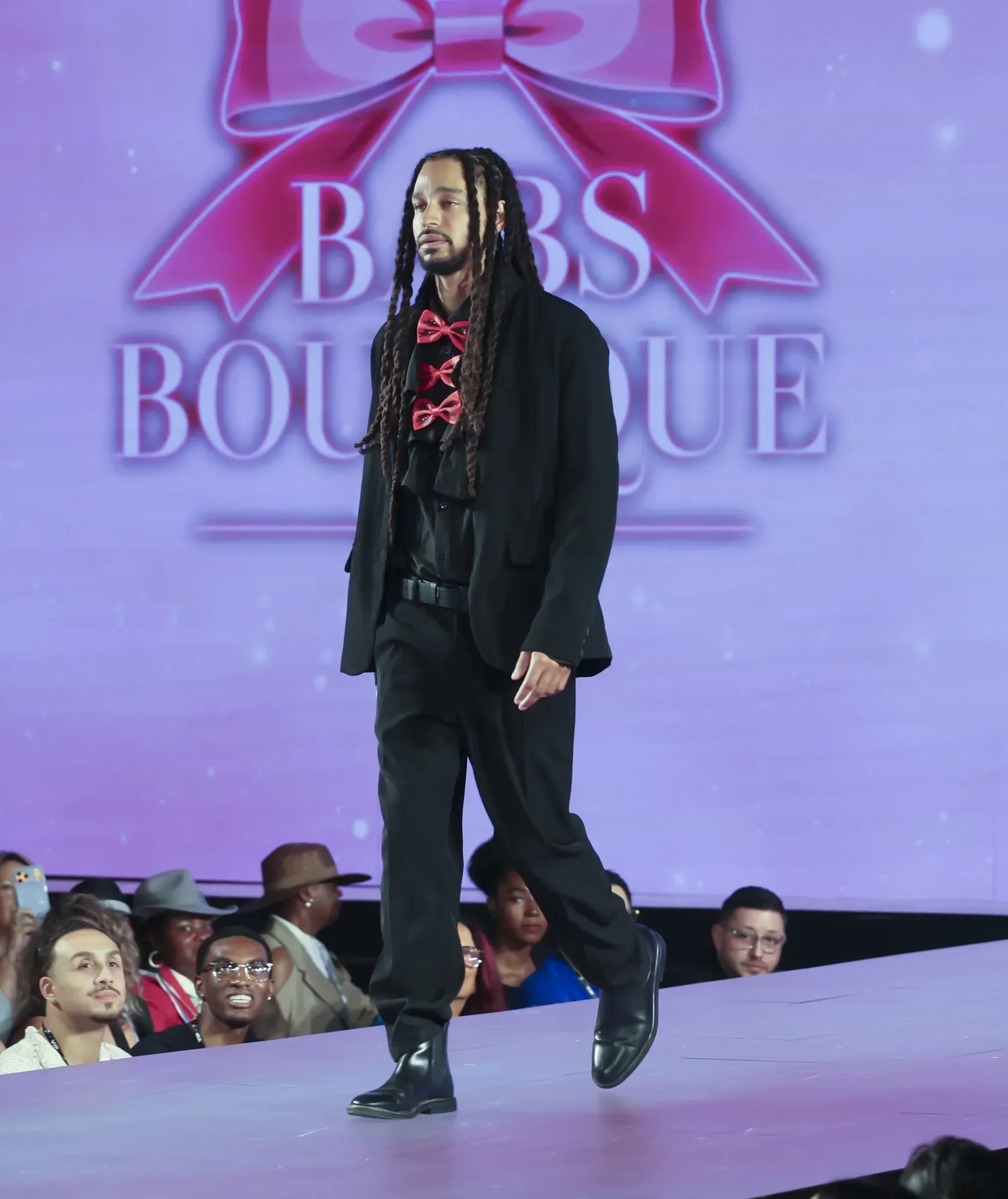 Black suit with red bow tie — Babs Boutique, Orlando Monroy Memorial Artist Collaboration Collection, New York Fashion Week