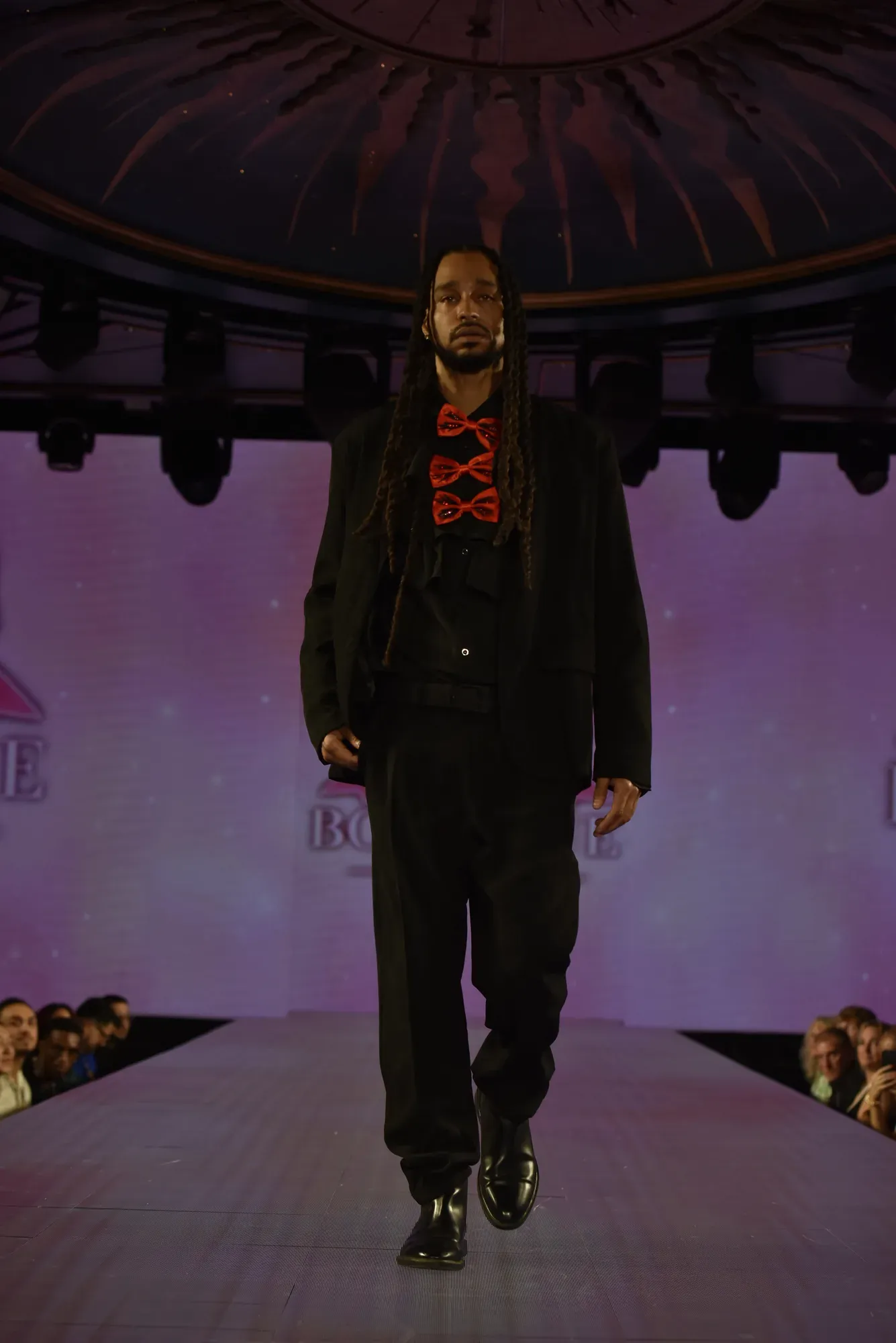 Black suit with red bow tie — Babs Boutique, Orlando Monroy Memorial Artist Collaboration Collection, New York Fashion Week