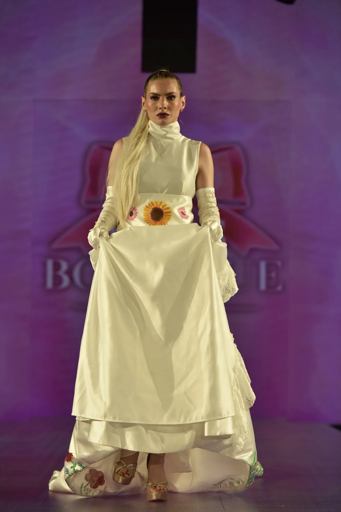 Ivory gown with sunflower appliqué — Babs Boutique, Orlando Monroy Memorial Artist Collaboration Collection, New York Fashion Week