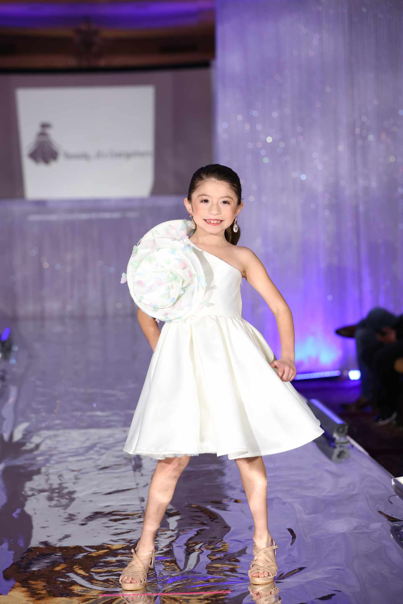 Model on the runway wearing the Butterfly Swirl Dress by Babs Boutique